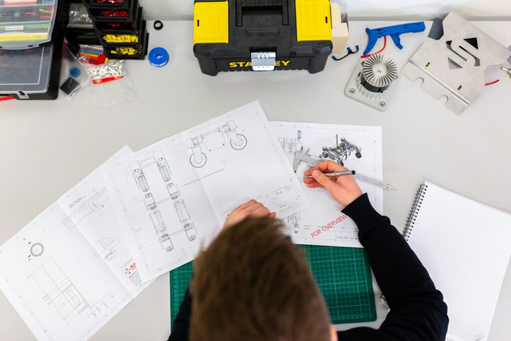 Engineer measuring technical drawings, engineering career scope