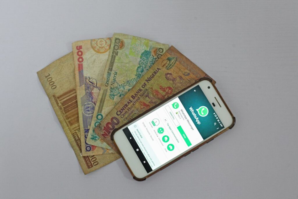 Smartphone and banknotes for sending money to Pakistan