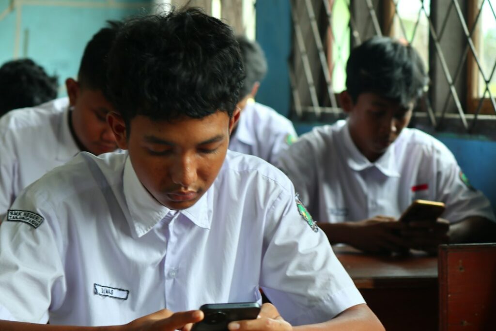 Students checking board exam result online on mobile phone